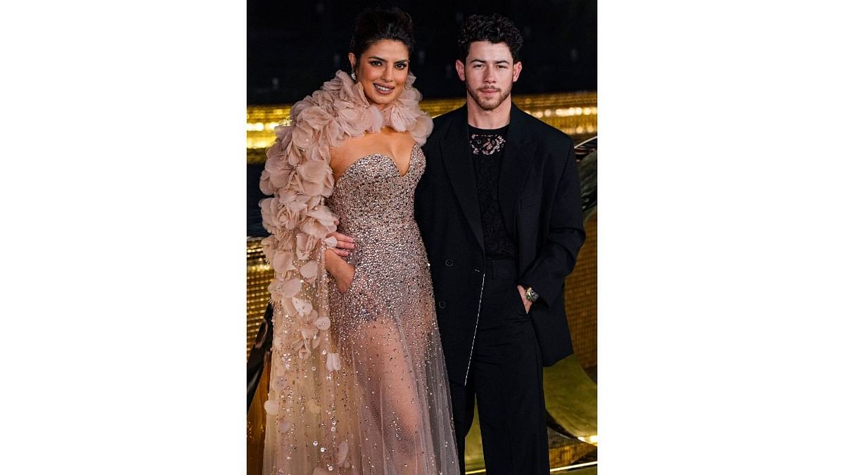 'Citadel' star, Priyanka Chopra and her husband Nick Jonas posed on their arrival. PC wore a shimmering dress with a cape around her neck while Nick opted for an all-black look. Credit: PTI Photo