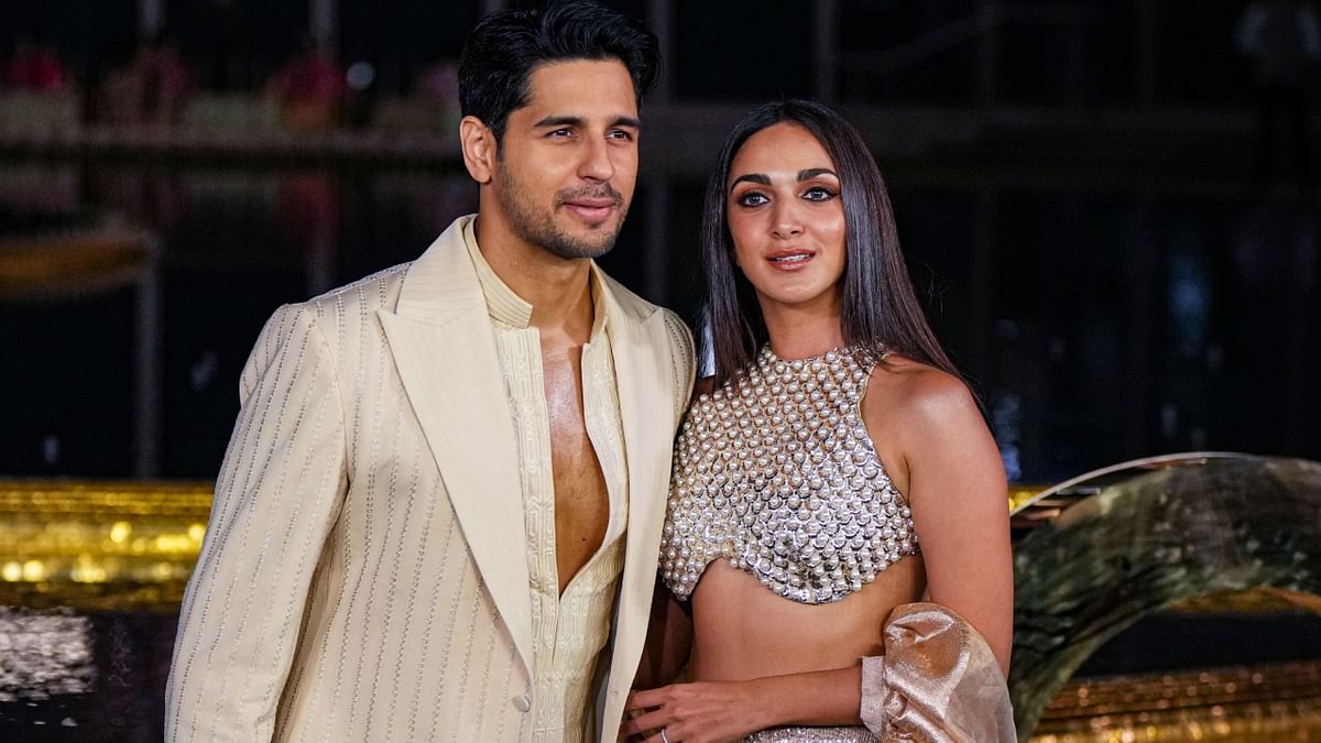 The newlyweds Sidharth Malhotra and Kiara Advani looked regal in ethnic wear in shade of off-white and silver. Credit: PTI Photo
