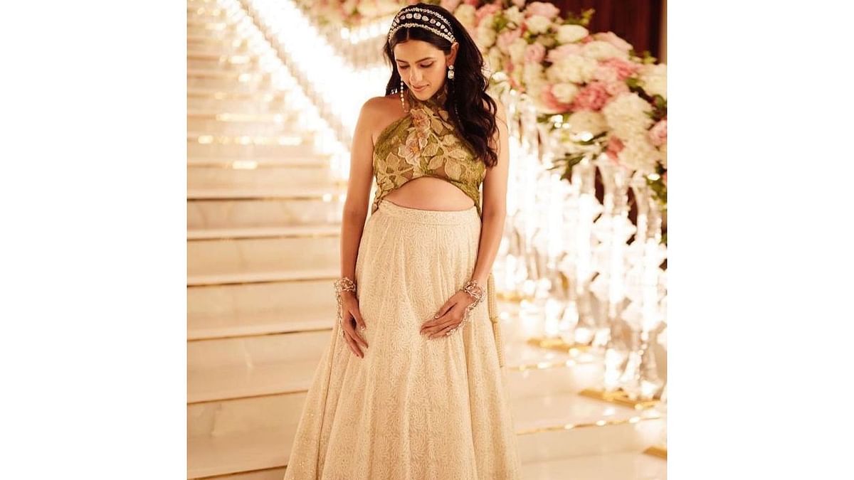 Celebrity saree draper Dolly Jain also shared few pictures of Shloka Mehta flaunting her bump on Instagram. The pictures went viral on social media. Credit: Instagram/@dolly.jain