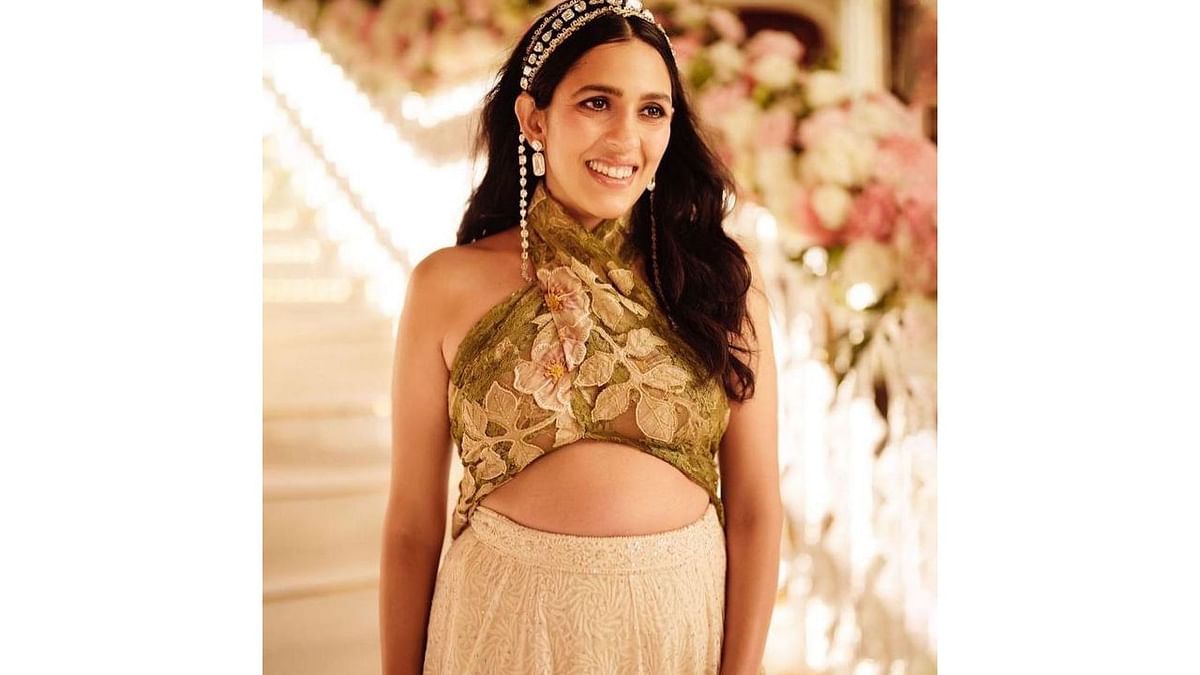 Shloka is seen donning a stylish embroidered top with a halter neckline and an intricately embroidered lehenga skirt at the NMACC launch Day 2. Credit: Instagram/@dolly.jain