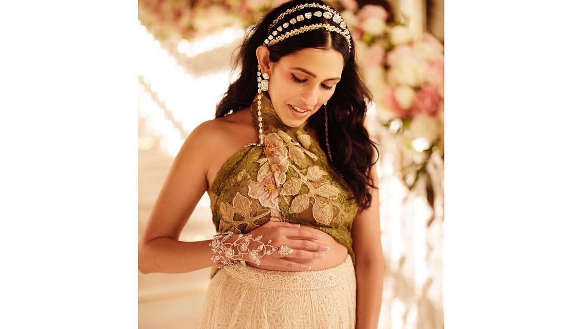 Shloka was seen cradling her baby bump in a stunning outfit. Credit: Instagram/@dolly.jain