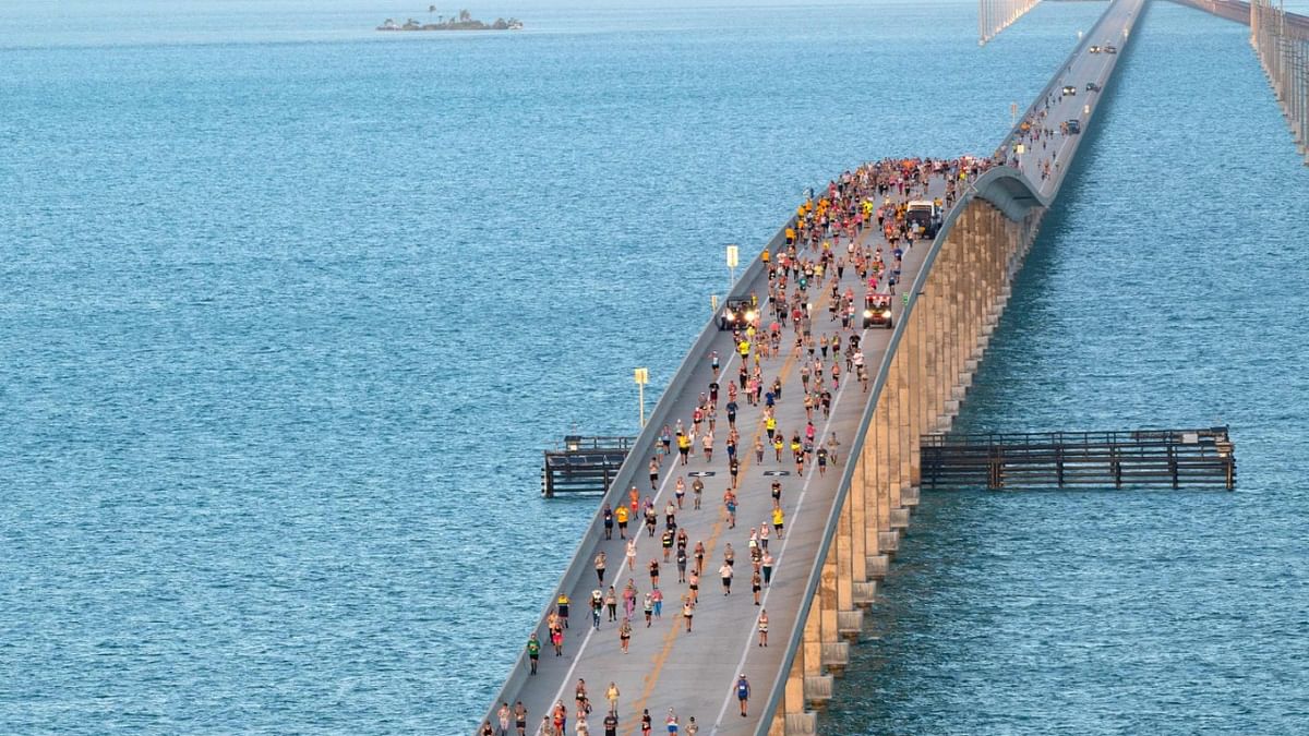 A portion of the field of 1,500 competitors reaches the highest point of the Seven Mile Bridge in the Florida Keys while competing in the annual Seven Mile Bridge Run near Marathon, Florida. Credit: AFP Photo