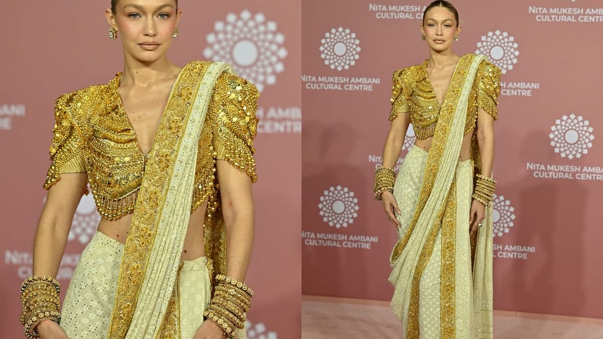 Supermodel Gigi Hadid looked drop-dead-gorgeous in her ivory and gold sari, paired with gold bangles and jewelled blouse. Credit: AFP Photo