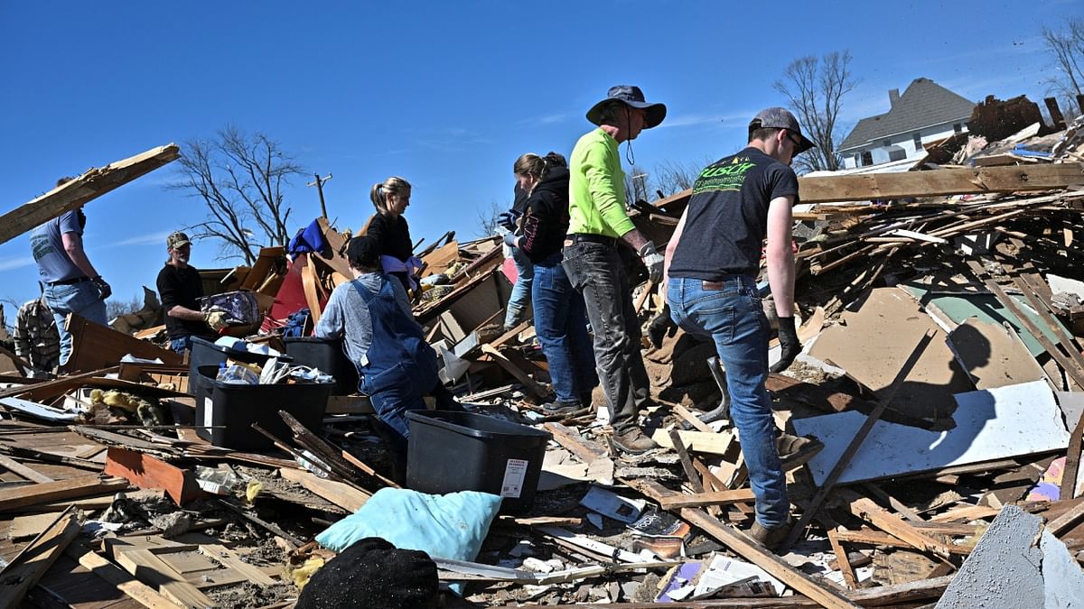 Community members and volunteers sort through the debris of a destroyed home, two days after a tornado hit Sullivan, Indiana, US. Credit: Reuters Photo