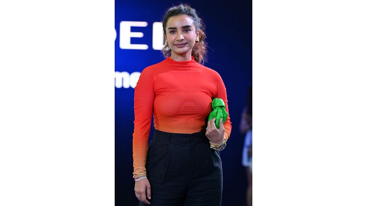 Actor Patralekhaa arrived in a pair of flared pants and red top. To bring an element of pop in her otherwise simple outfit, she carried a green handbag. Credit: AFP Photo