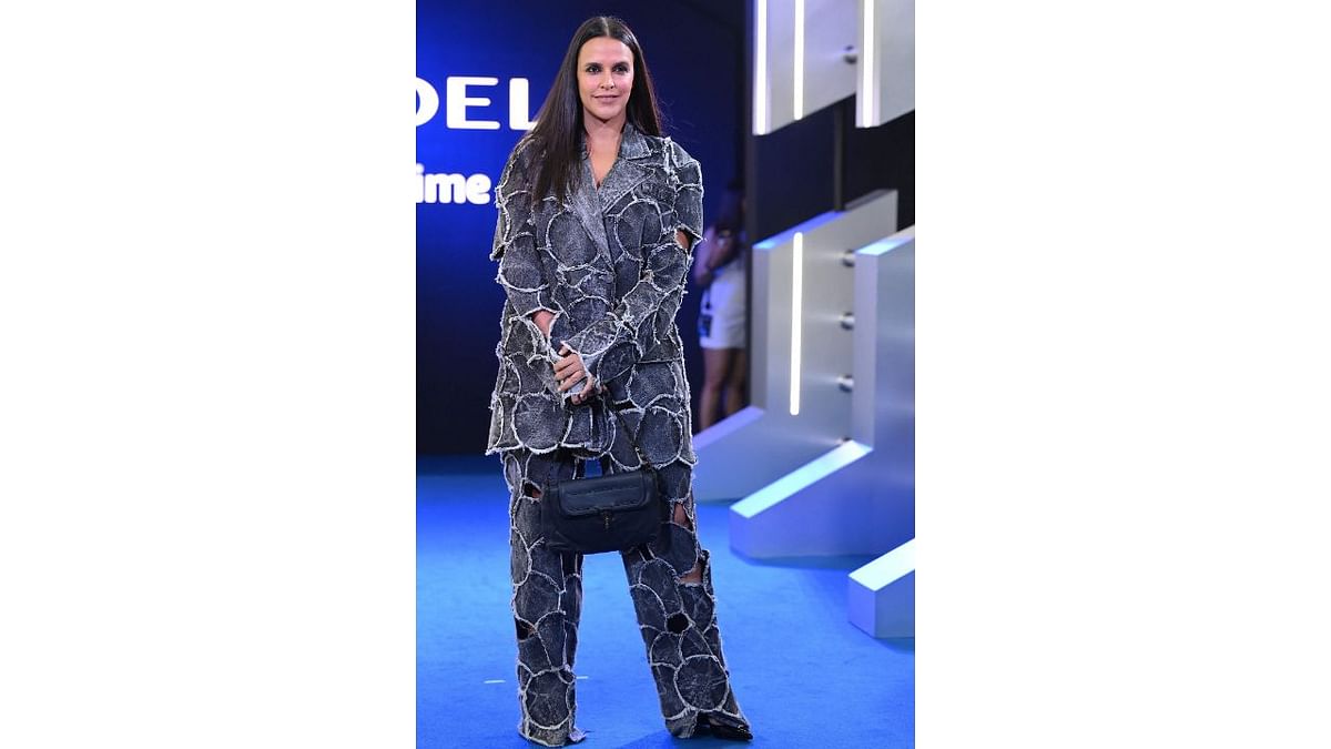 Neha Dhupia flaunted an oversized matching separates for the event. She topped her look with a black purse and middle parted straight hair. Credit: AFP Photo
