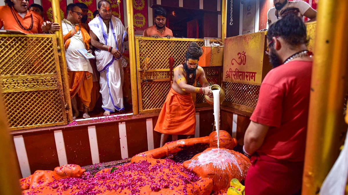 Mahant of Baghambari Math Balveer Giri Maharaj performs 'abhishek' of Lord Hanuman at Bade Hanuman Ji temple on the occasion of 'Hanuman Jayanti', near Sangam in Prayagraj. Credit: PTI Photo