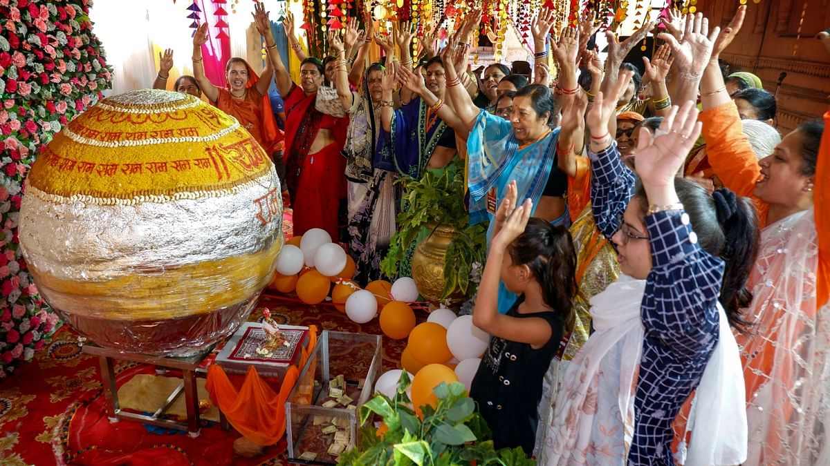 Devotees offer prayers near an 1100 kg laddoo, prepared to offer to Lord Hanuman, on the eve of Hanuman Jayanti, at the Pachmattha temple, in Jabalpur. Credit: PTI Photo