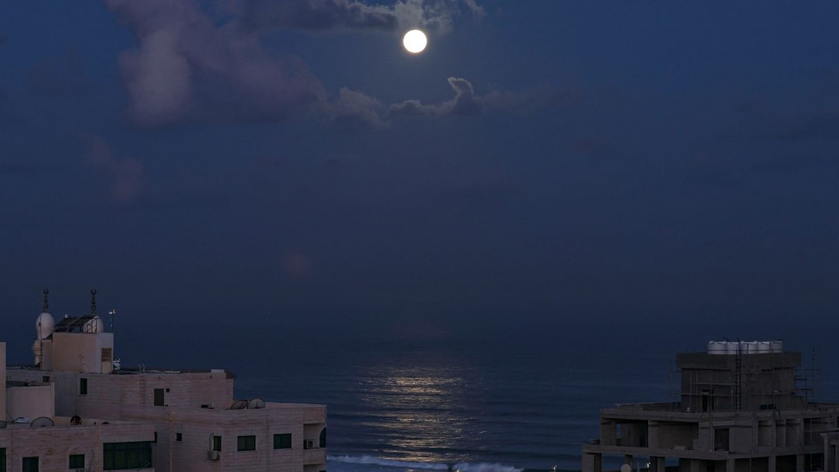 The full moon rises over the Mediterranean Sea in Gaza City. Credit: AFP Photo