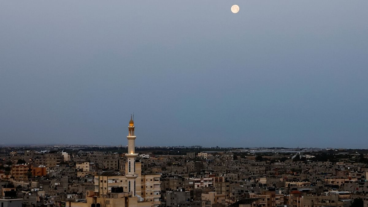 The moon appears in the sky, in Khan Younis in the southern Gaza Strip. Credit: Reuters Photo