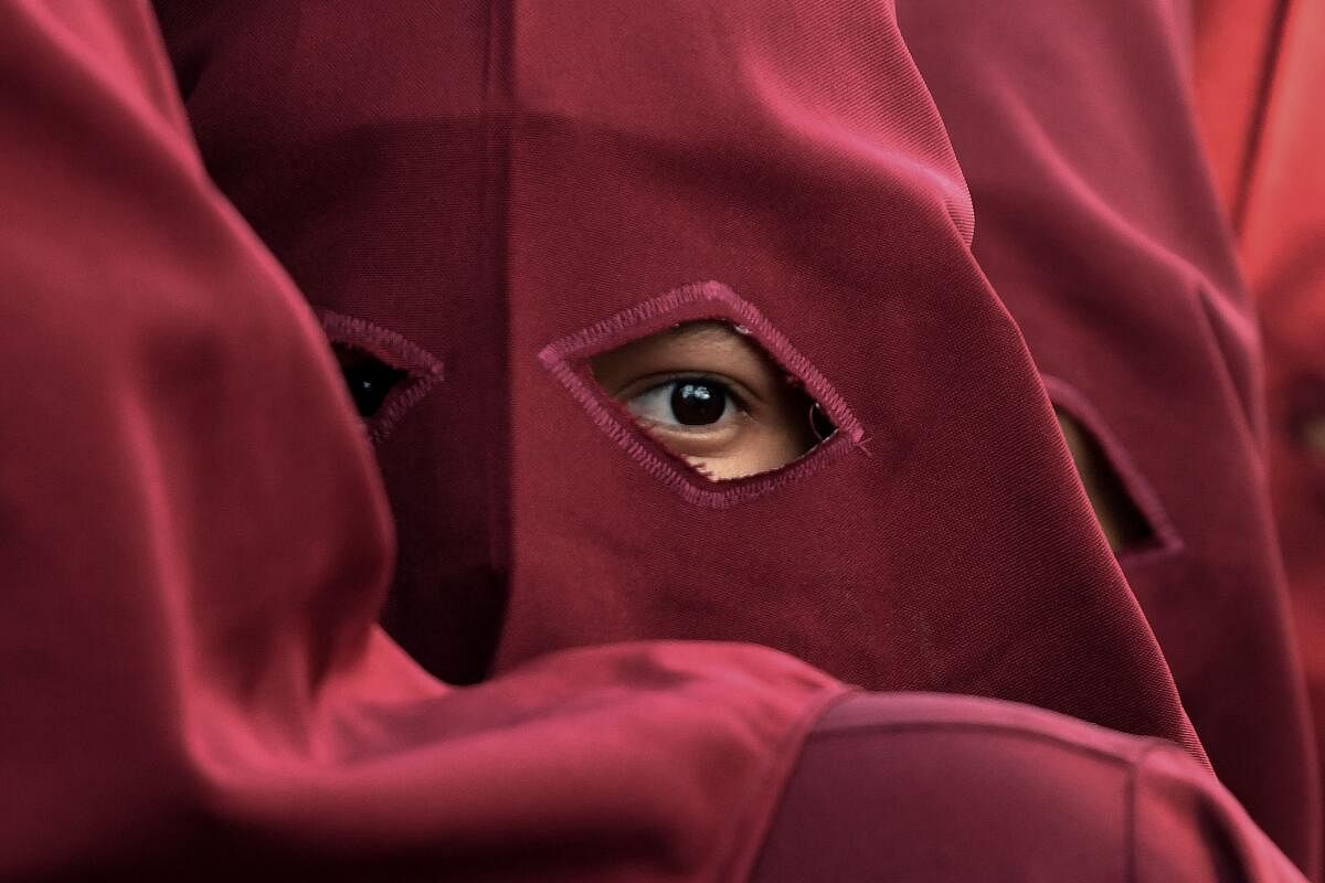 An eye of a worshipper is seen under his conical hood as he takes part in a Good Friday procession in Comayagua, Honduras. Credit: AFP Photo