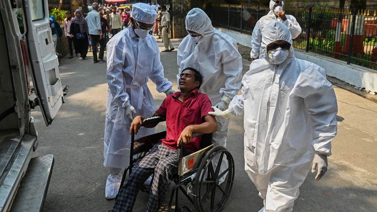 Health workers wearing Personal Protective Equipment (PPE) take part in a mock drill to check preparations of Covid-19 facilities at a hospital in Mumbai. Credit: AFP Photo