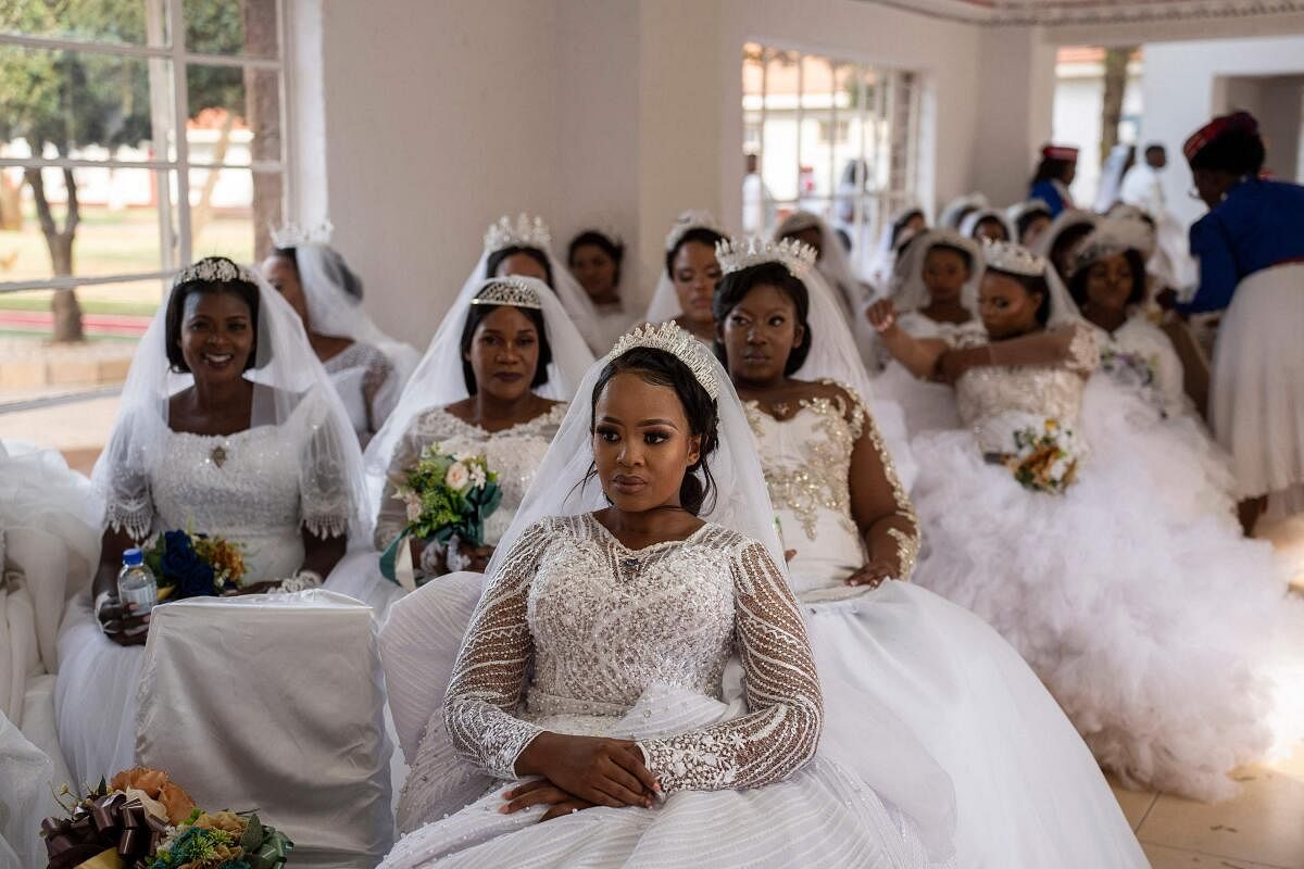 A group of brides are seen waiting at the International Pentecostal Holiness Church in Zuurbekom, south of Johannesburg, as they take part in a mass wedding ceremony where 80 couples got married during the Easter Sunday service. credit: AFP