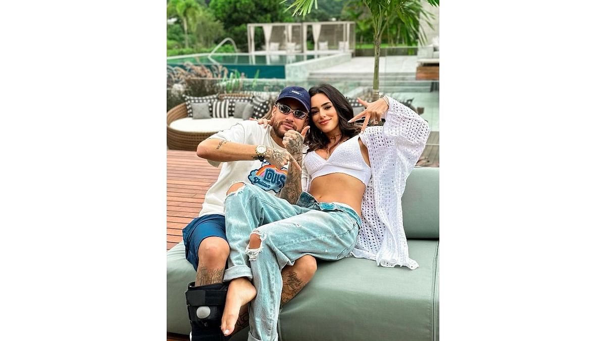 The much in love couple also shared a picture of Neymar pointing at Bruna's belly as she smiled at the camera. Credit: Instagram/@brunabiancardi