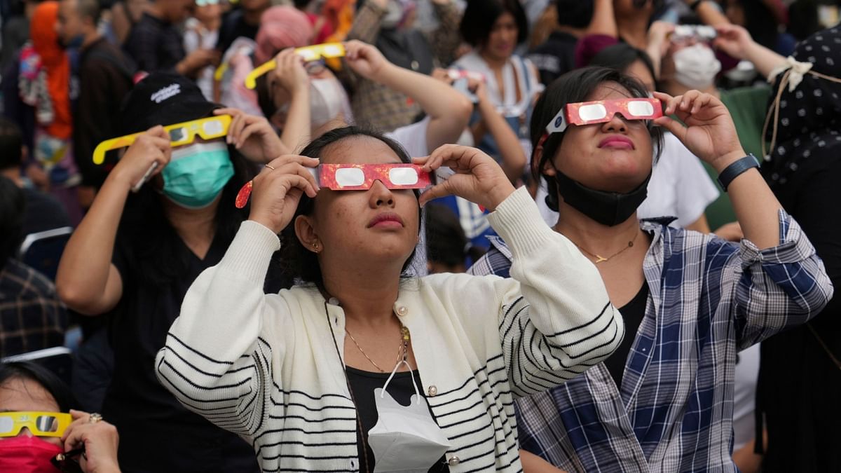 People use protective glasses to watch the solar eclipse in Jakarta, Indonesia. Credit: AP Photo