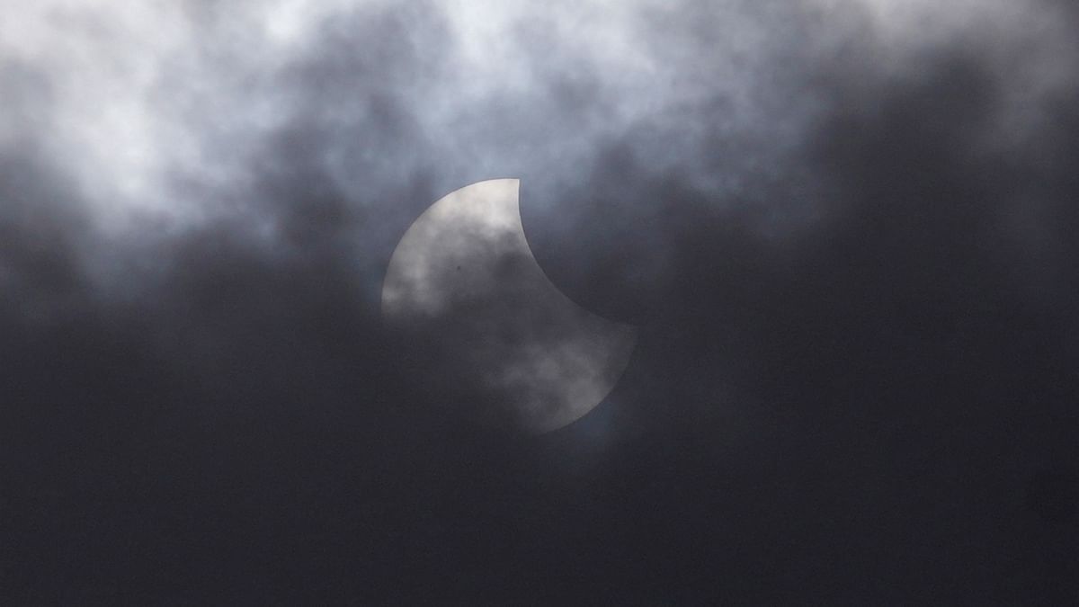 In Indonesia's capital, hundreds came to see the partial eclipse, obscured by clouds. Credit: AP Photo