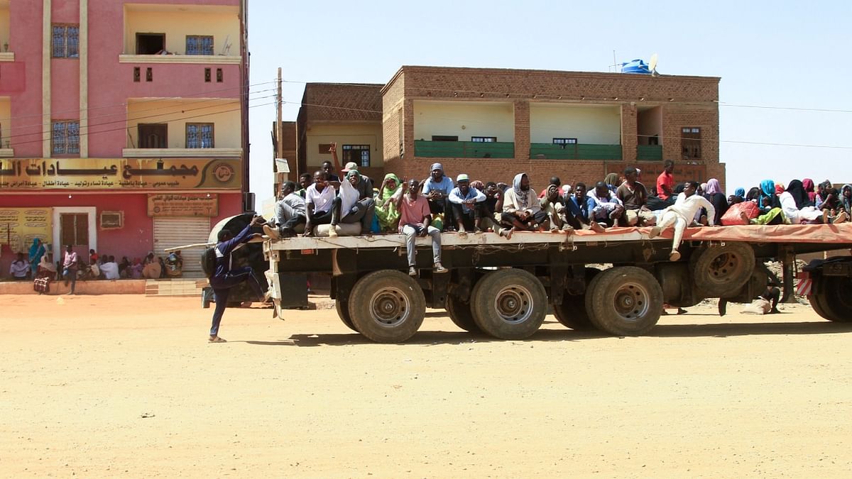 People fleeing street battles between the forces of two rival Sudanese generals, are transported on the back of a truck in the southern part of Khartoum. Credit: AFP Photo