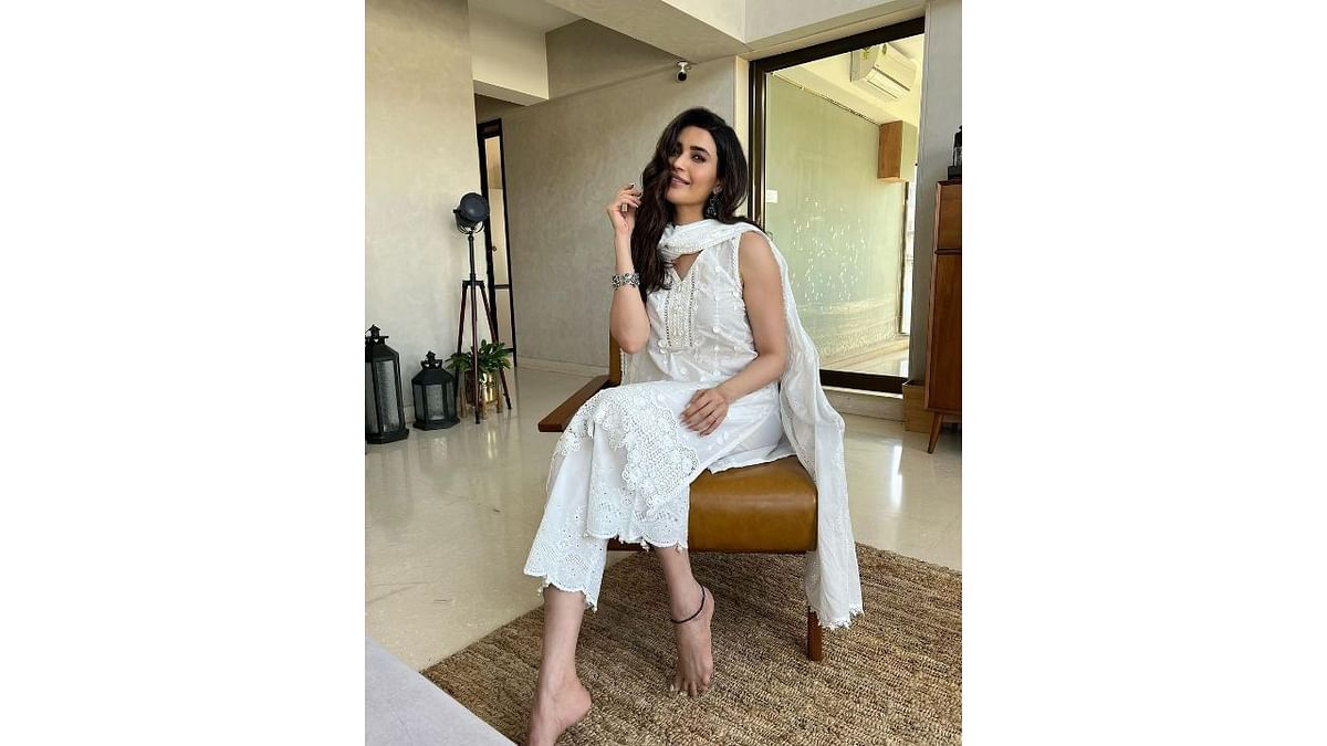 Hot and humid weather calls for breezy looks. An all-white embroidered kurta set can never be boring. Details like lace-edged pants instead of traditional churidar can be used to give the overall look a modern update. Credit: Instagram/@karishmaktanna