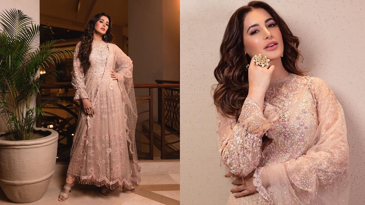 Nargis dazzles in a floral tulle anarkali that features multi-coloured aari thread work, sequins, crystals, and kundan details, from Tarun Tahiliani's Sheer Summer Bridal Collection. Credit: Instagram/@nargisfakhri