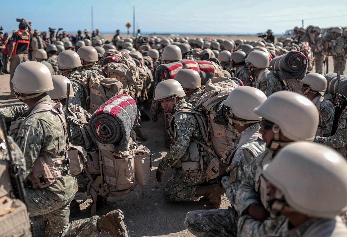 Peruvian soldiers stand on arrival for surveillance and patrol operations, in Tacna, in the Peru-Chile border on April 28. Credit: AFP Photo