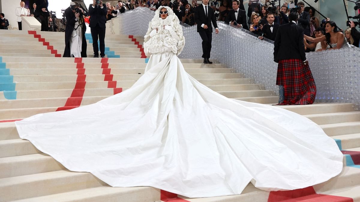Rihanna wore a long skirt and an enormous floral hood, all in white, with sunglasses and gloves from Valentino's collection. Credit: Reuters Photo