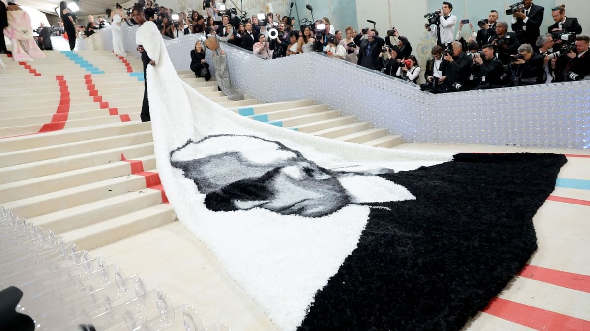 American actor Jeremy Pope walked in a 32-foot cape emblazoned with the visage of Karl Lagerfeld. Credit: AFP Photo
