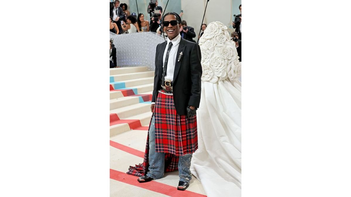 A$AP Rocky wore a red tartan skirt over crystal-studded jeans with a train of his own. Credit: AFP Photo