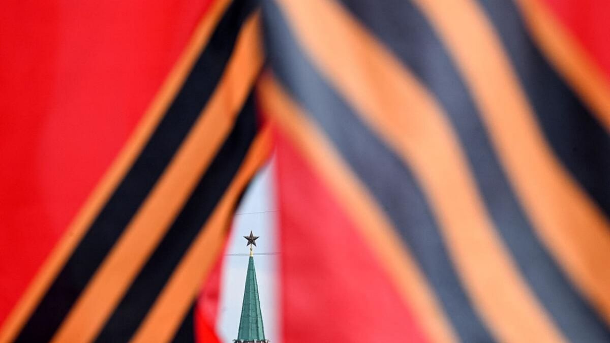One of the Kremlin tower is pictured through a street decoration in the colours of patriotic black and orange Saint George's ribbon ahead of the Victory Day in central Moscow on May 5, 2023. - Russia will celebrate the 78th anniversary of the 1945 victory over Nazi Germany on May 9. Credit: AFP Photo