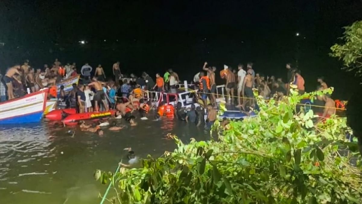 Dozens of people searched for survivors in and around the stricken vessel during the night, which was partially submerged. Some used ropes to stabilise the vessel while others were in the water, looking for survivors. Credit: PTI Photo