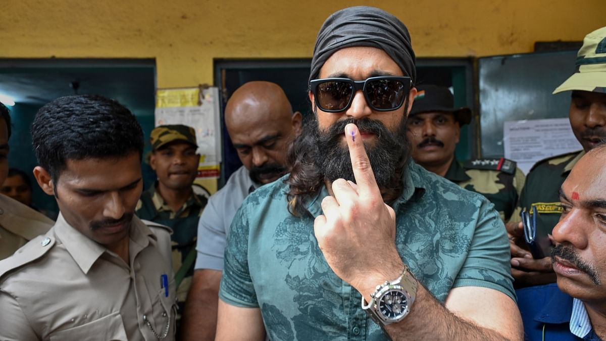 KGF star Yash shows his ink-marked finger after casting his vote in the Karnataka Assembly elections, in Bengaluru. Credit: PTI Photo