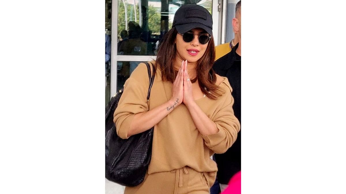 Priyanka greeted photographers with folded hands at airport while getting papped. Credit: IANS Photo
