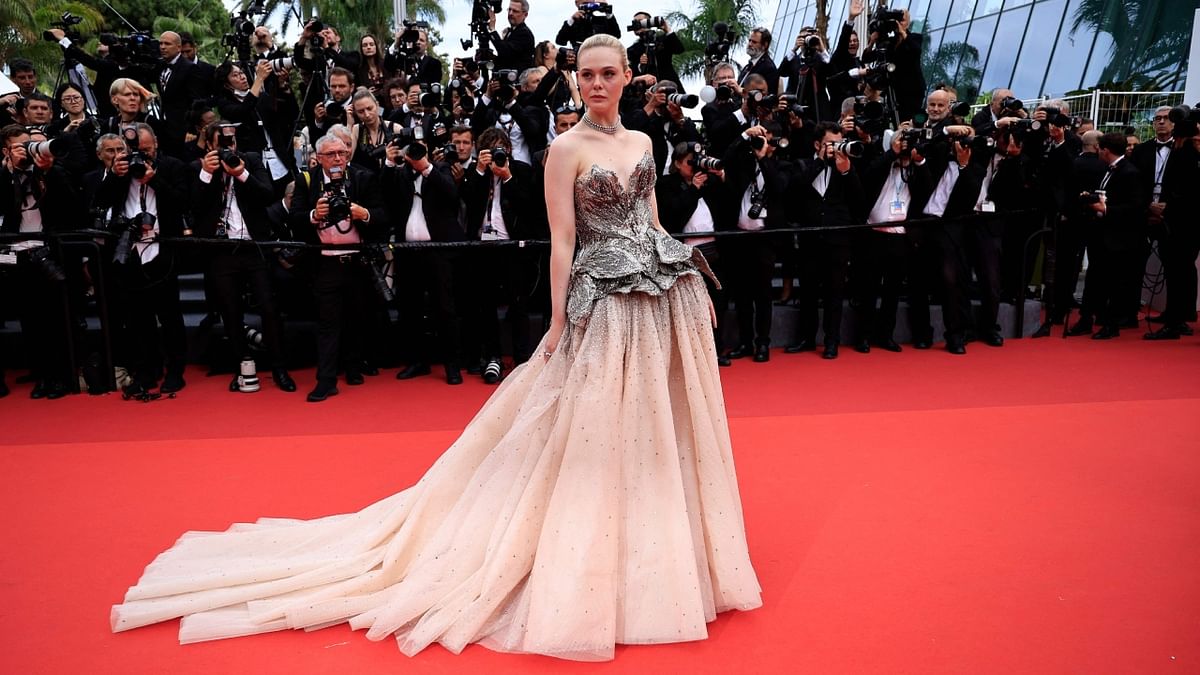 American actress Elle Fanning wore a romantic ballgown with crystal-studded blush skirt and intricately worked silver bodice which she complimented with a Cartier necklace. Credit: AFP Photo