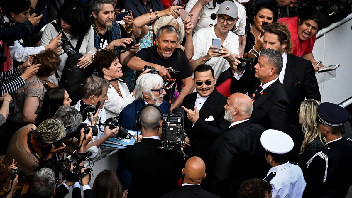 Hollywood superstar Johnny Depp seemed to be back in full celebrity mode, signing autographs and taking pictures with fans before the premiere of the Cannes Film Festival's opening film 'Jeanne du Barry,' which marks the actor's first major role since his high-profile defamation trial. Credit: AFP Photo