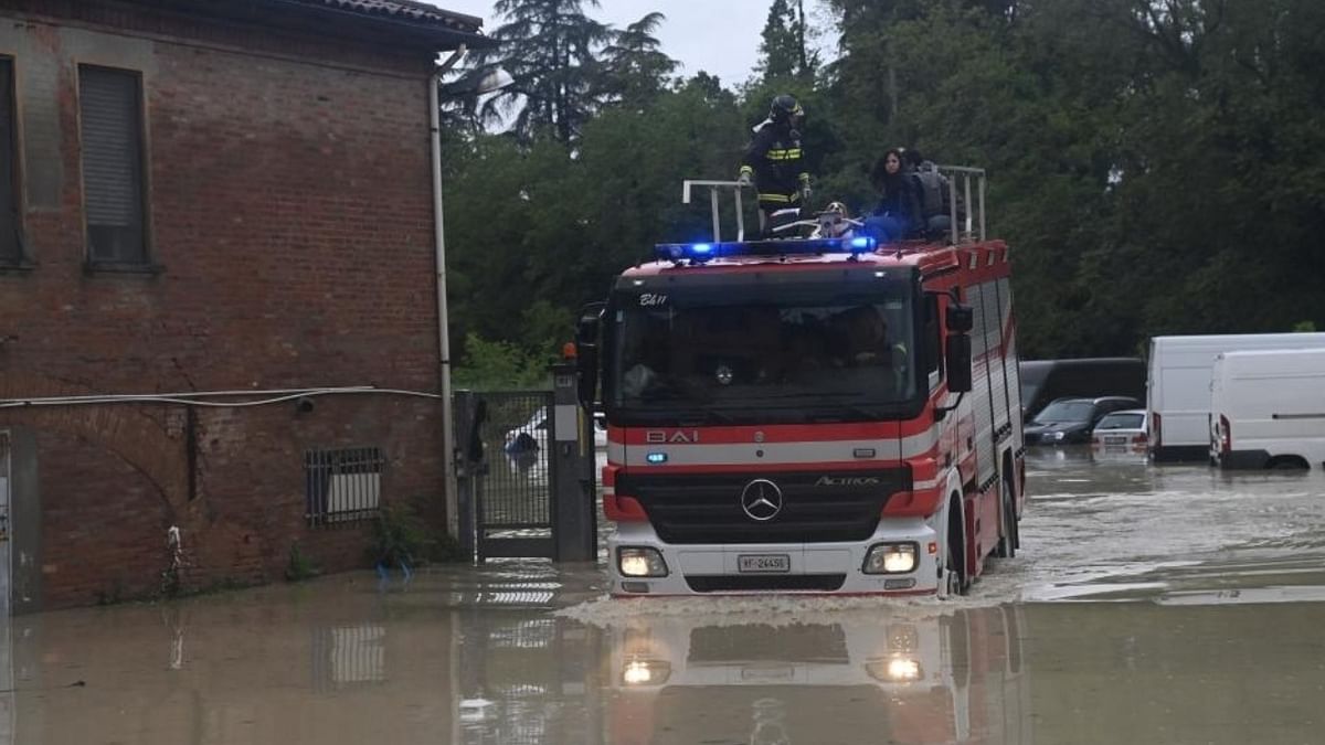 Rescuers work in a flooded area in Bologna, Emilia-Romagna region, Italy. Credit: IANS Photo