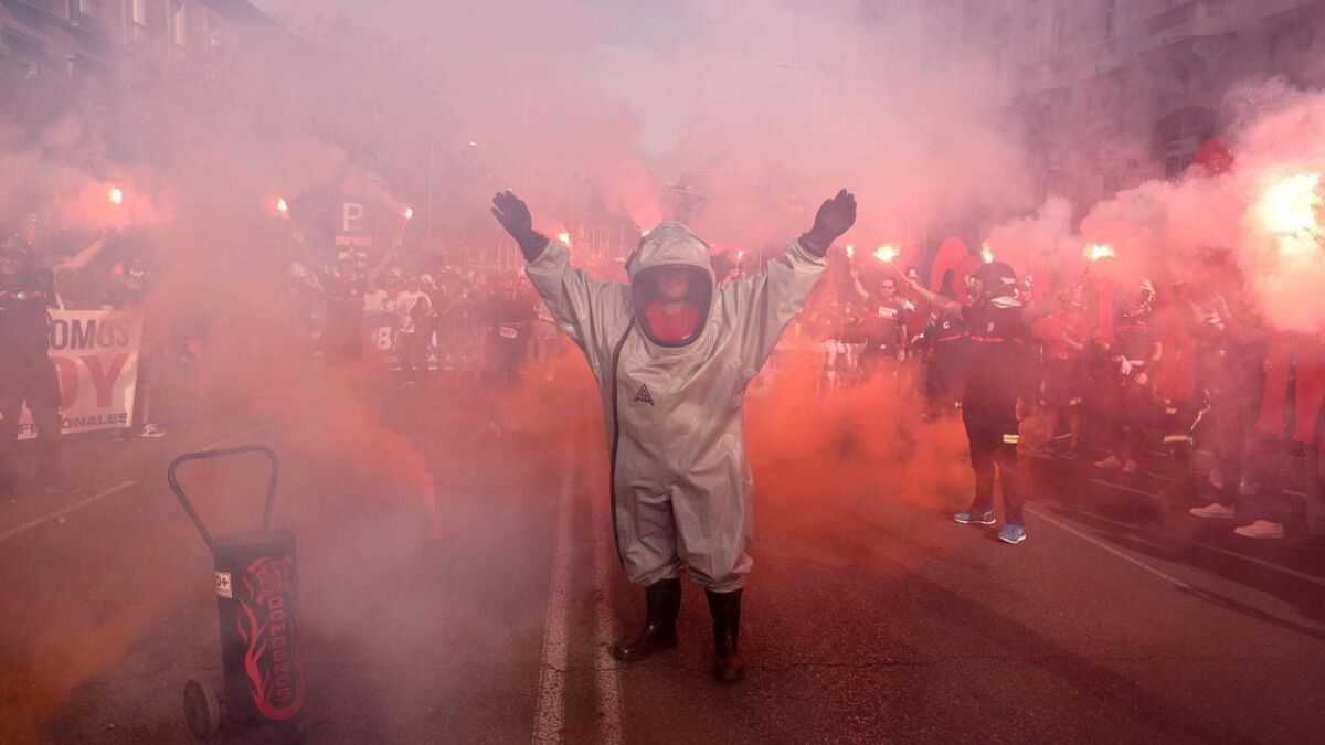 A firefighter gestures during a protest against a political blocking of a law that would allow all fire-fighting services to be coordinated, in front of the Spanish Congress in Madrid on May 16, 2023. Credit: AFP Photo