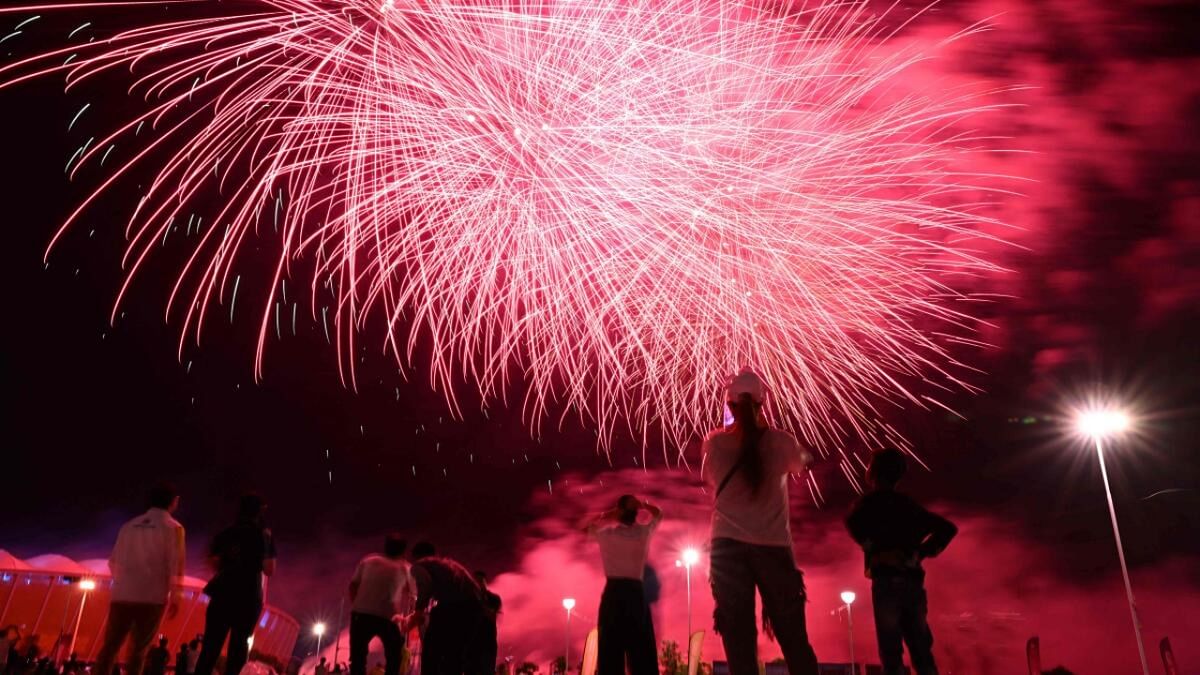 People watch fireworks exploding during the closing ceremony of the 32nd Southeast Asian Games (SEA Games) at the Morodok Techo National Stadium in Phnom Penh on May 17, 2023. Credit: AFP Photo
