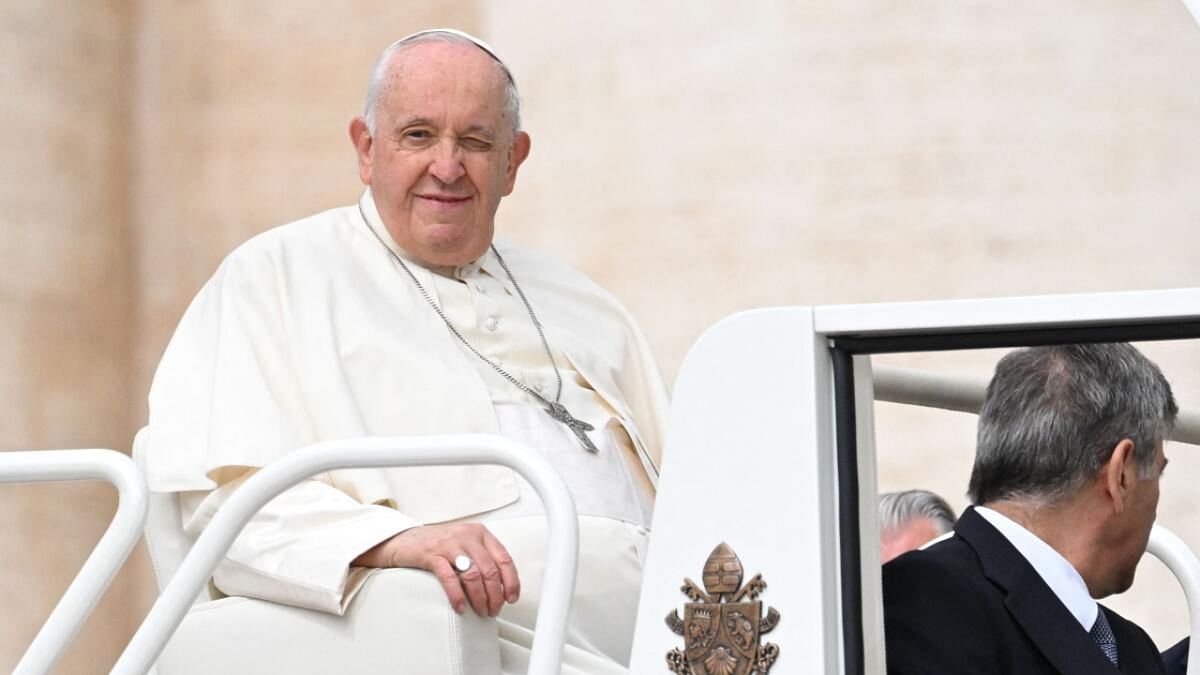 Pope Francis (C) winks as he leaves after the weekly general audience at St. Peter's square in The Vatican on May 17, 2023. Credit: AFP Photo