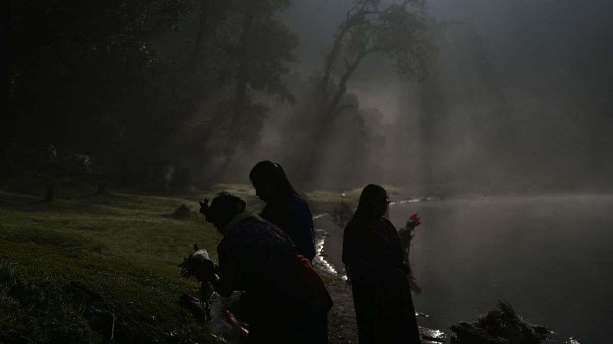 Indigenous women take part in the 'Prayer for Rain' ceremony on the shore of the Chicabal Lagoon, formed on the crater of a former volcano and considered by Mayan people as a sacred place, in San Martin Sacatepequez, Guatemala, on May 18, 2023.