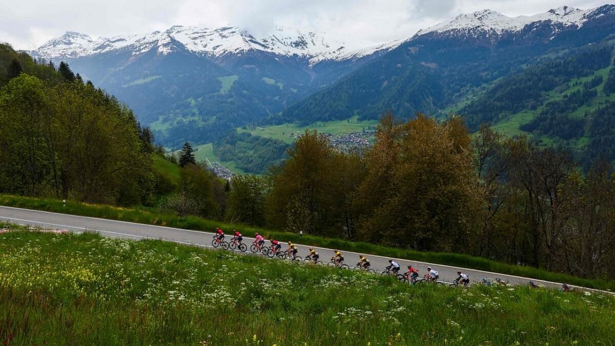 Riders of the pack cycle during the thirteenth stage of the Giro d'Italia 2023 cycling race, which start was transfered from Borgofranco d'Ivrea to Le Chable due to bad weather conditions, and Crans-Montana, on May 19, 2023. Credit: AFP Photo