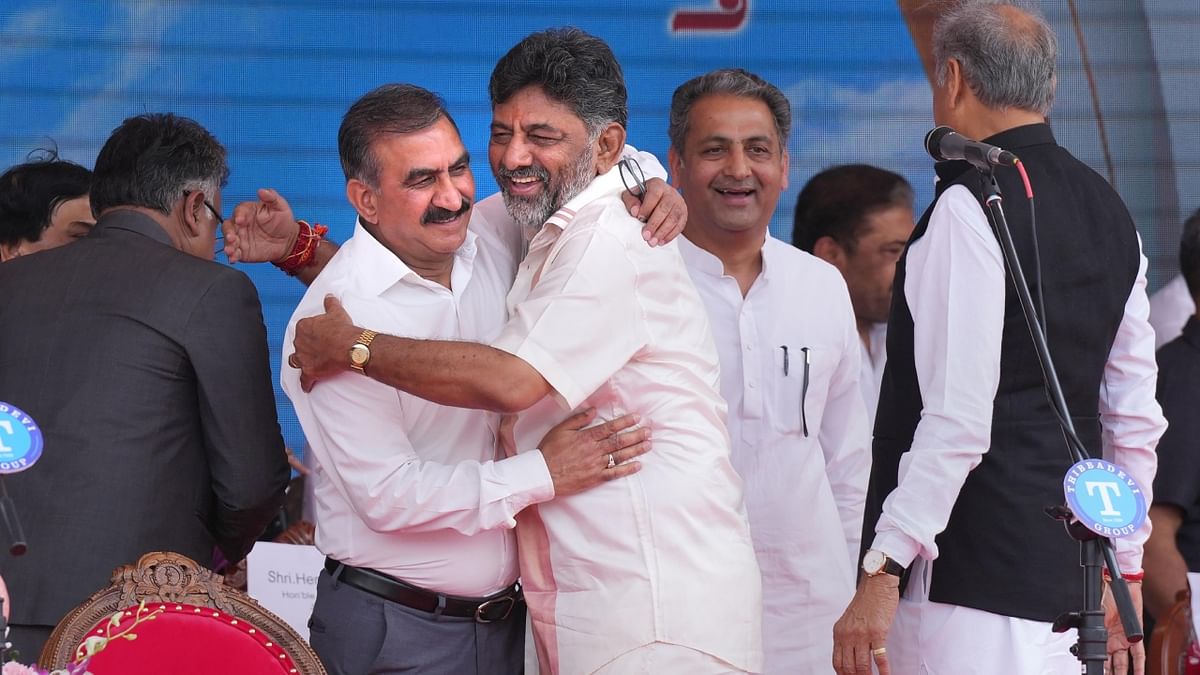 Newly-elected Karnataka deputy Chief Minister D K Shivakumar with Himachal Pradesh Chief Minister Sukhvinder Singh Sukhu during the swearing-in ceremony of Congress government at Kanteerava Stadium, in Bengaluru. Credit: PTI Photo