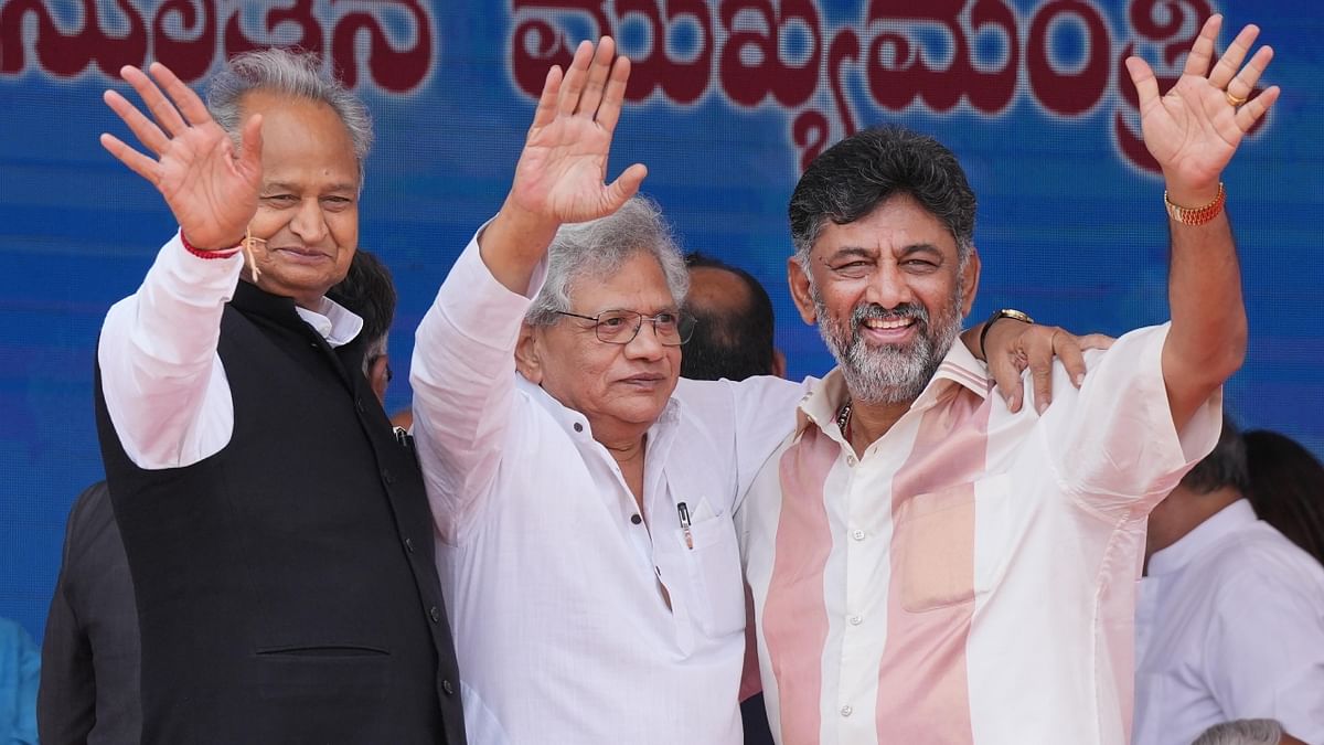 Newly-elected Karnataka deputy Chief Minister DK Shivakumar waves at the public with CPI(M) leader Sitaram Yechuri and Rajasthan Chief Minister Ashok Gehlot. Credit: PTI Photo