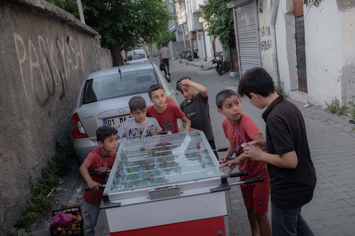 Syrian children play foosball on the street in the Kocavezir neighborhood of Adana, in southern Turkey, which hosts a large number of Syrian refugees who fled the civil war, on May 25, 2023. Credit: AFP Photo