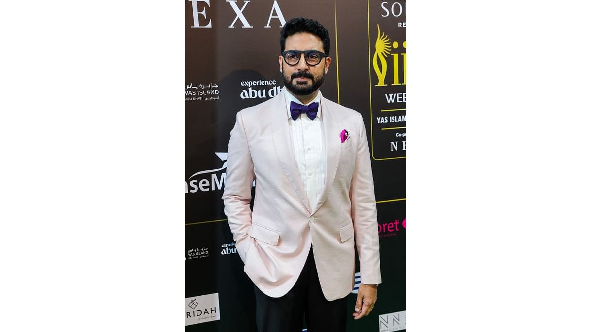 Abhishek Bachchan looked dapper in black pant which he paired with white shirt and pink coat and a bow tie. Credit: AFP Photo