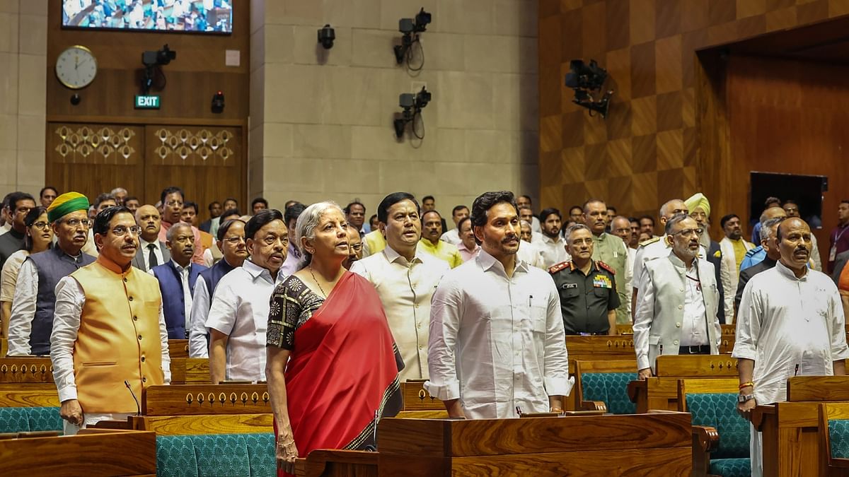 Union Minister for Finance and Corporate Affairs Nirmala Sitharaman, Union Minister for Parliamentary Affairs, Coal and Mines Pralhad Joshi and other dignitaries stand for National Anthem during inauguration ceremony of the new Parliament building, in New Delhi. Credit: PTI Photo