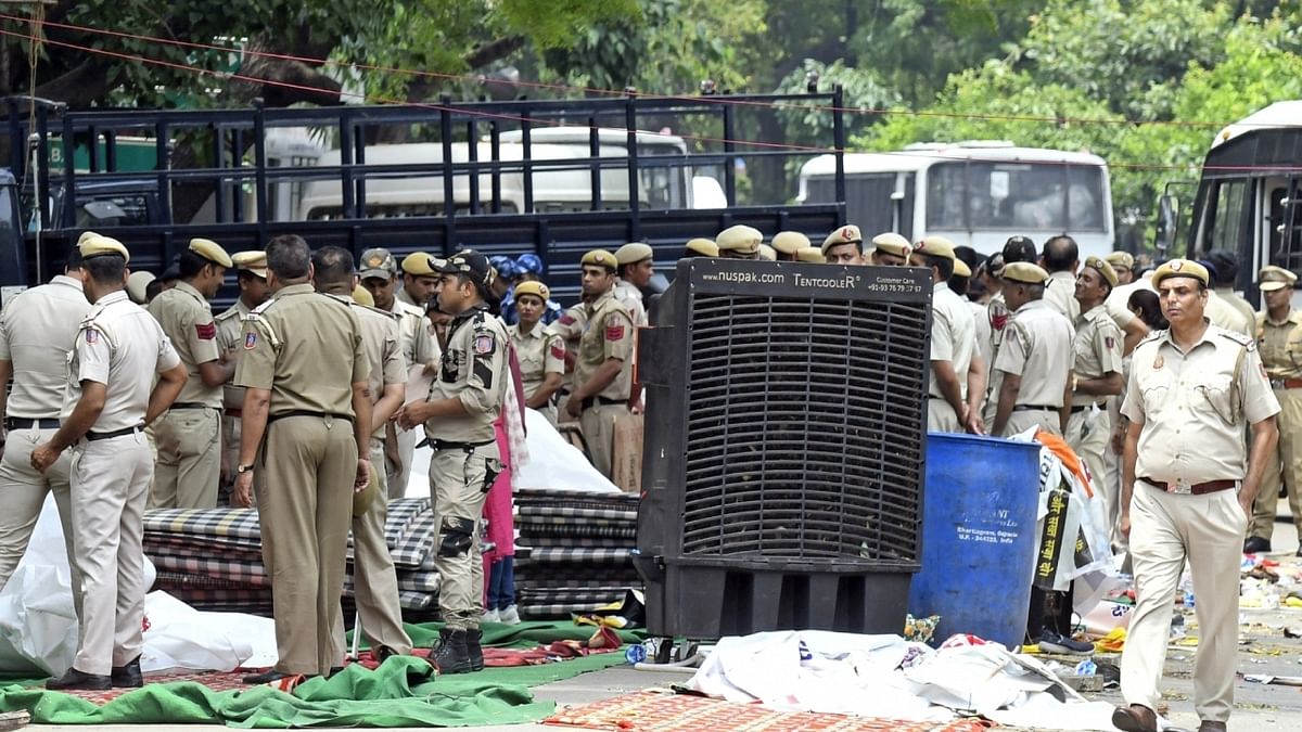 Security personnel clear the Wrestlers protest site, at Jantar Mantar, in New Delhi. Credit: IANS Photo