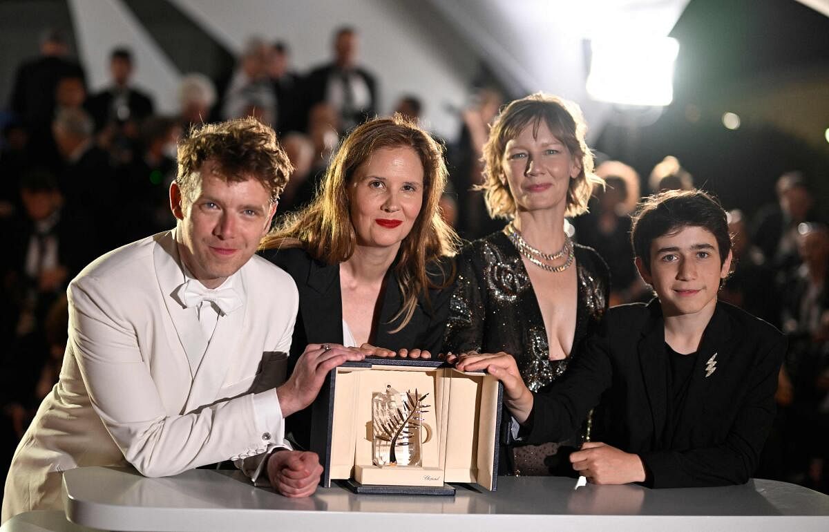 French director Justine Triet (2ndL) poses French actor Antoine Reinartz, German actress Sandra Hueller and actor Milo Machado Graner during a photocall after she won the Palme d'Or for the film