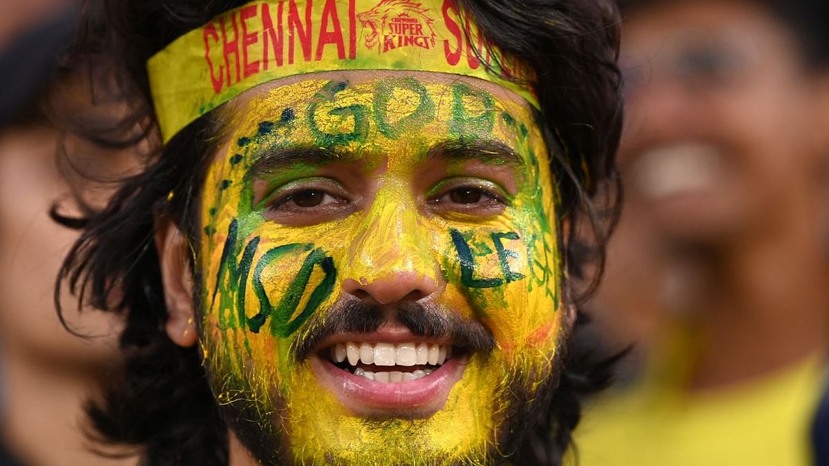 A Chennai Super Kings' fan spotted with his face painted in yellow during the Indian Premier League (IPL) Twenty20 final cricket match between Gujarat Titans and Chennai Super Kings at the Narendra Modi Stadium in Ahmedabad. Credit: AFP Photo
