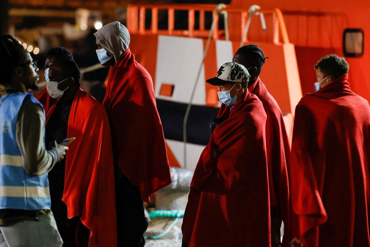 Migrants walk towards a Red Cross tent after disembarking from a Spanish coast guard vessel in the port of Arguineguin, in the island of Gran Canaria Spain. Credit: Reuters Photo
