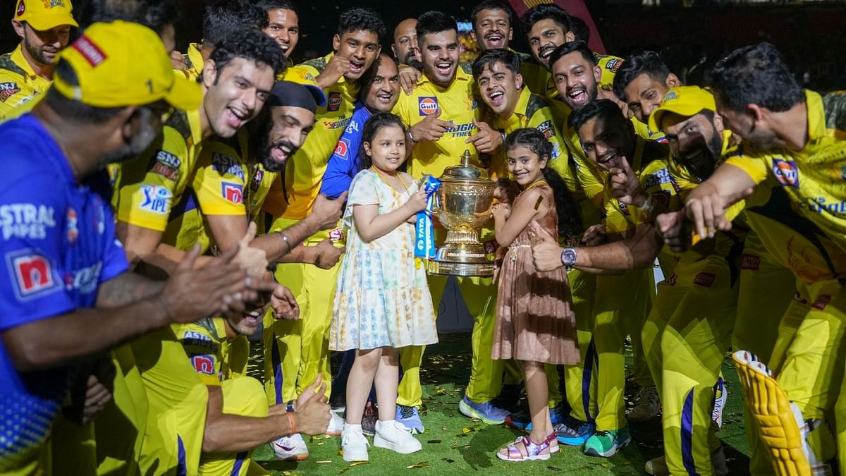 Chennai Super Kings players celebrate with the trophy after winning the Indian Premier League (IPL) 2023 at the Narendra Modi Stadium in Ahmedabad. Credit: PTI Photo