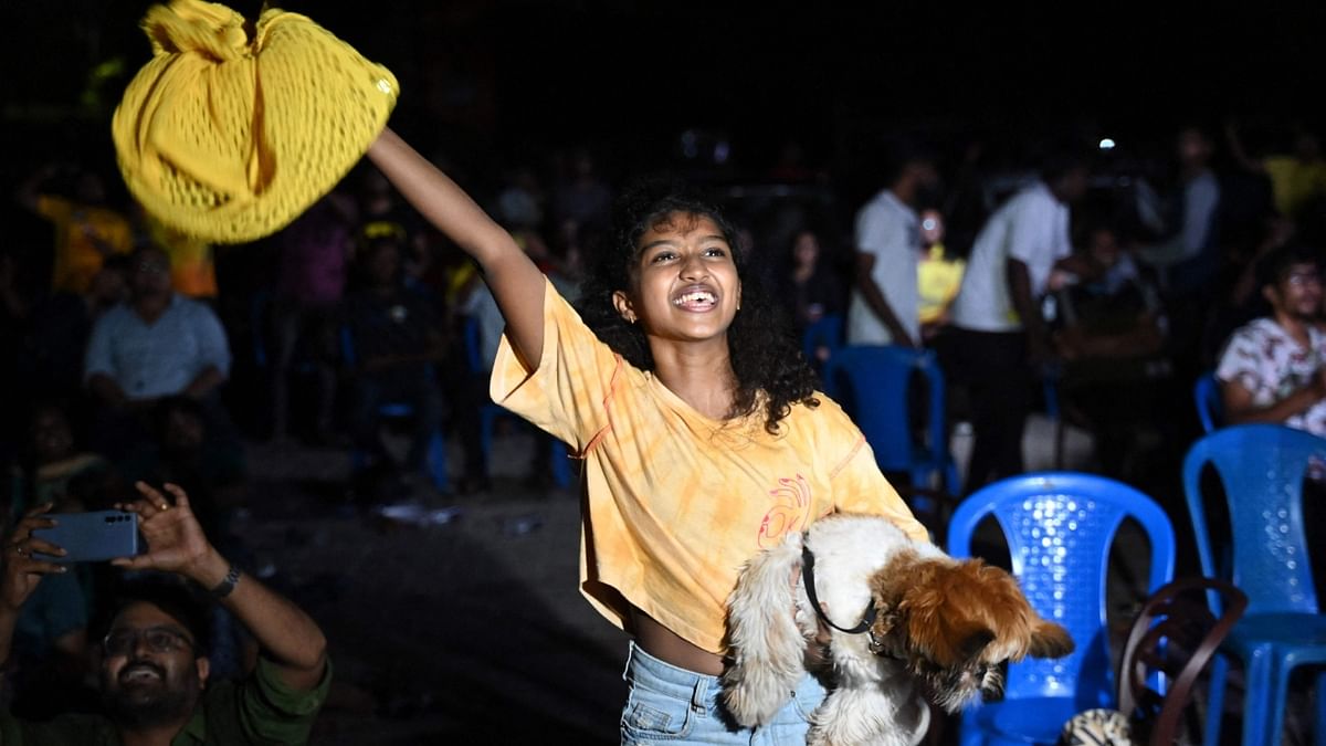 A Chennai Super Kings fan celebrates her team's win at the end of the Indian Premier League (IPL) Twenty20 final cricket match between Gujarat Titans and Chennai Super Kings, in Chennai. Credit: AFP Photo